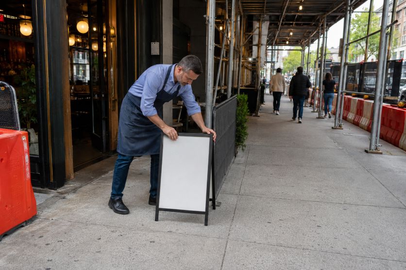 Restaurant Owner Safely Adjusts Sidewalk Sign